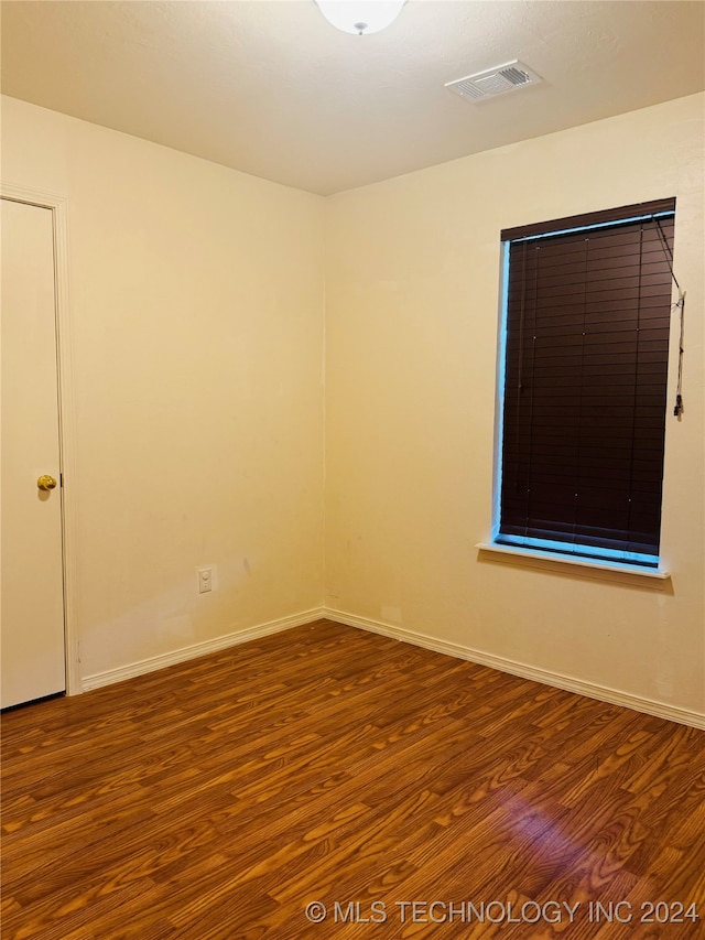 empty room with hardwood / wood-style flooring