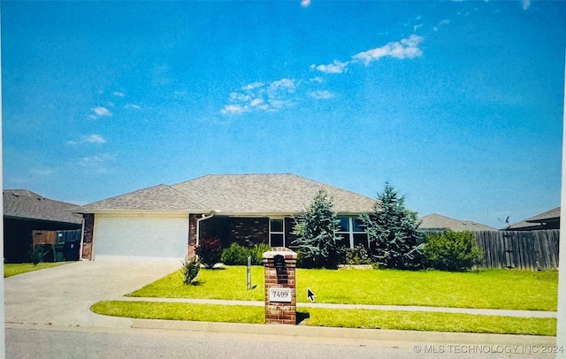 single story home featuring a garage, brick siding, fence, concrete driveway, and a front lawn