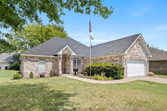 ranch-style home featuring driveway, a front lawn, an attached garage, and a shingled roof