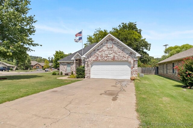 view of front of house with a garage and a front yard