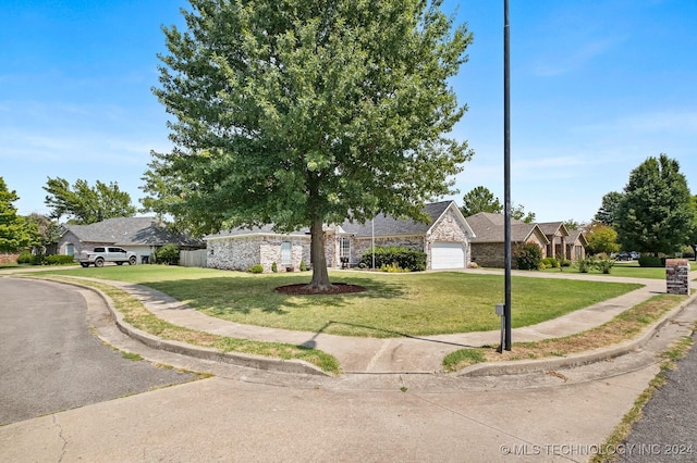 view of front of property with a garage and a front yard