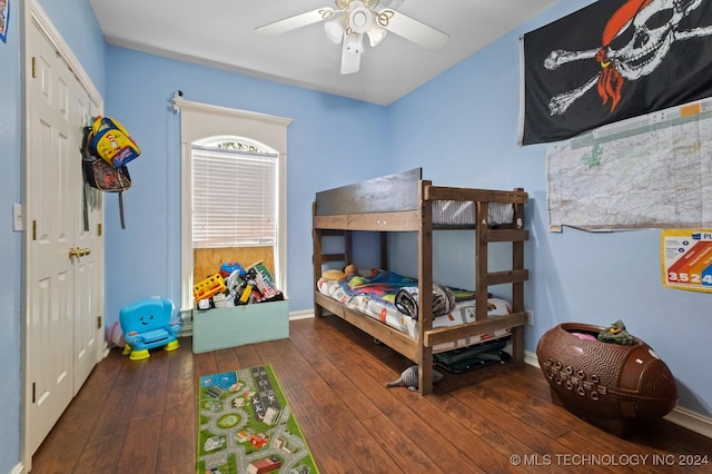 bedroom with ceiling fan, hardwood / wood-style flooring, and baseboards