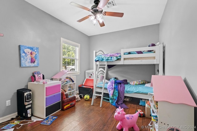 bedroom with hardwood / wood-style flooring, visible vents, and a ceiling fan