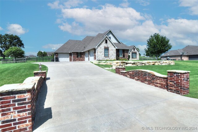 view of front of property featuring a garage and a front lawn