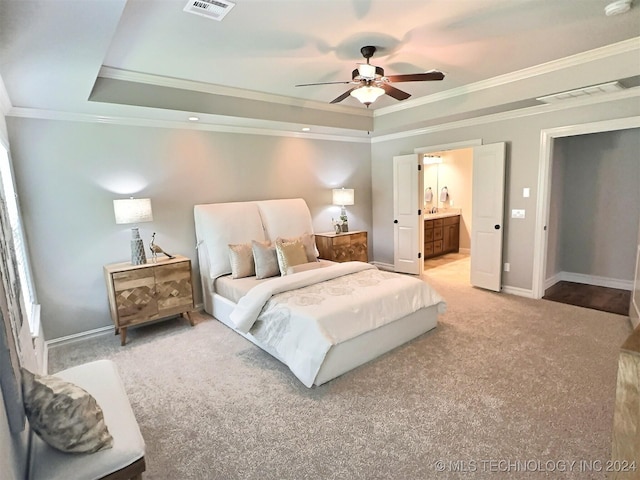 carpeted bedroom featuring a tray ceiling, visible vents, and baseboards