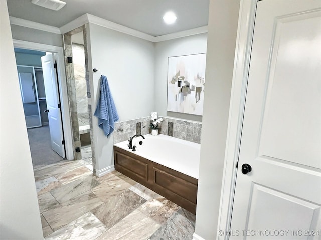 bathroom featuring ornamental molding, a stall shower, and a bath