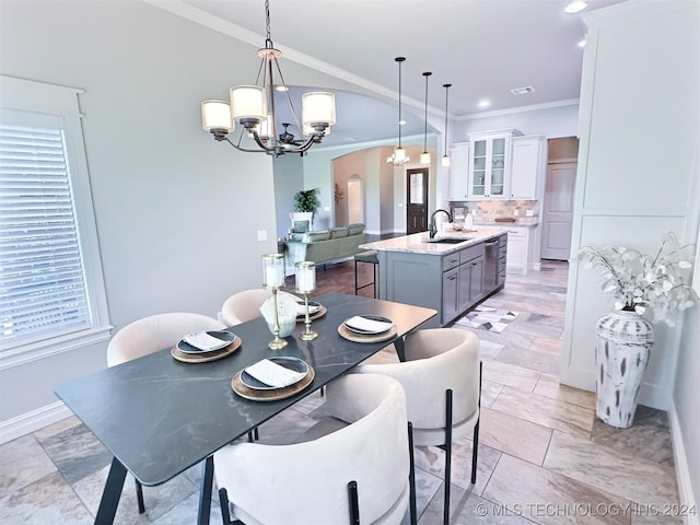 dining space featuring visible vents, a chandelier, arched walkways, and ornamental molding