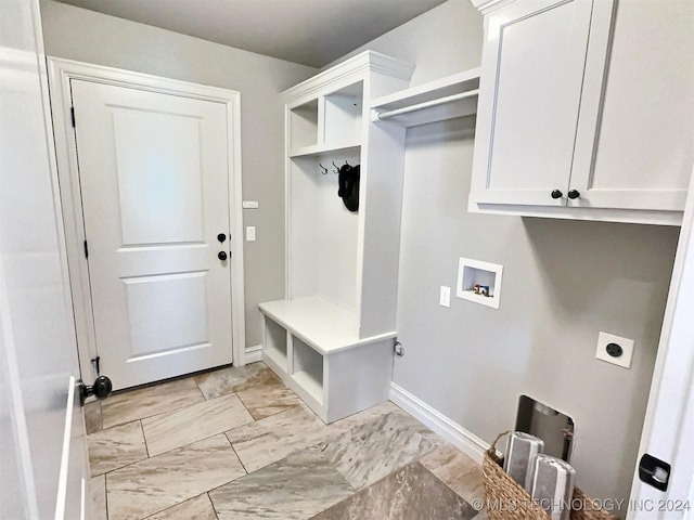 mudroom with marble finish floor and baseboards