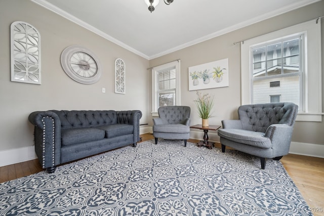 living room with lofted ceiling, ornamental molding, and light wood-type flooring