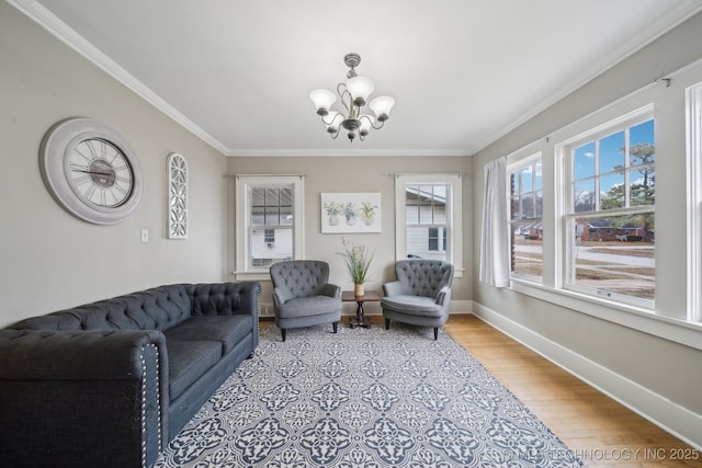 living room featuring crown molding, a chandelier, and light wood-type flooring