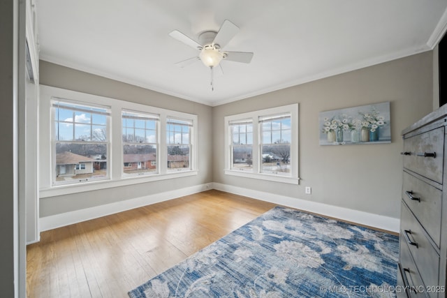 unfurnished room with ornamental molding, ceiling fan, and light wood-type flooring