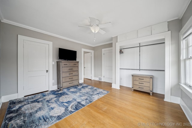 bedroom featuring hardwood / wood-style flooring, ceiling fan, and ornamental molding