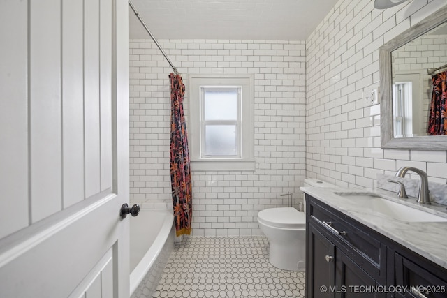 full bathroom featuring tile walls, vanity, shower / bath combo, and toilet