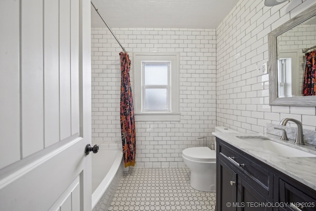 1715 Grandview Ave, Pawhuska, OK 74056 - bathroom featuring vanity, tile walls, tile patterned flooring, and shower / bath combo