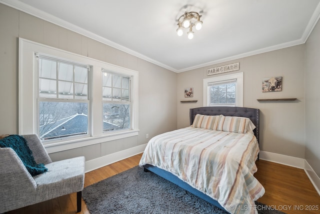 bedroom featuring crown molding and wood-type flooring