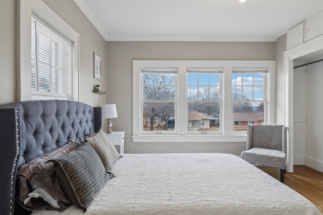 bedroom featuring hardwood / wood-style floors and crown molding