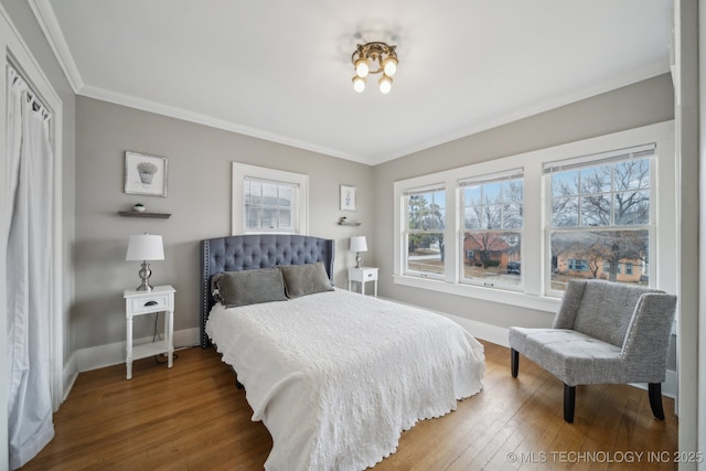 bedroom featuring ornamental molding and hardwood / wood-style floors