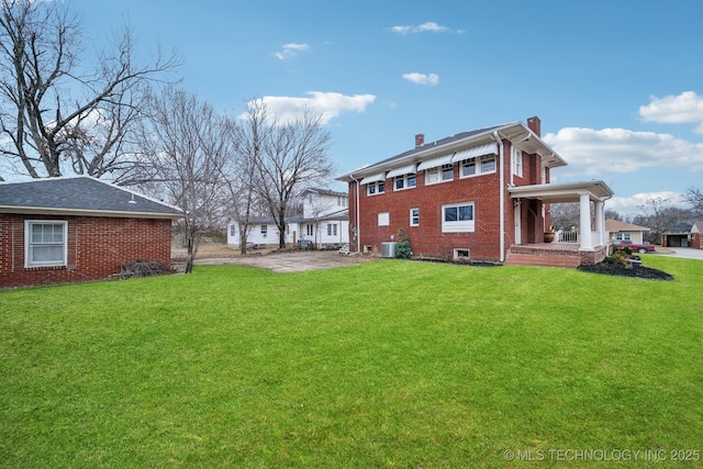 rear view of property with a yard