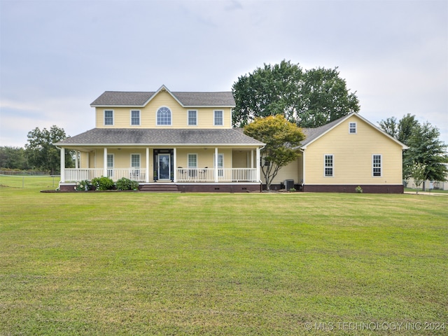 country-style home with a front yard, a porch, and cooling unit