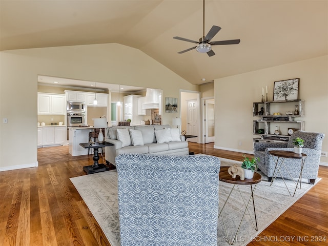 living room featuring high vaulted ceiling, hardwood / wood-style floors, and ceiling fan