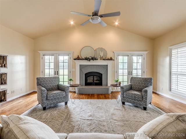 living room with light wood-type flooring, ceiling fan, plenty of natural light, and french doors