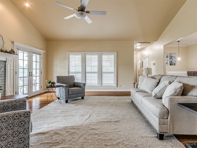 living room featuring french doors, lofted ceiling, hardwood / wood-style floors, and ceiling fan