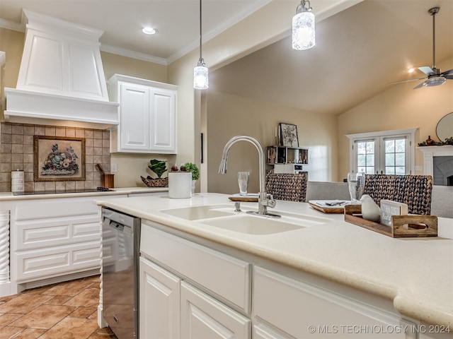 kitchen featuring a fireplace, backsplash, sink, ceiling fan, and vaulted ceiling