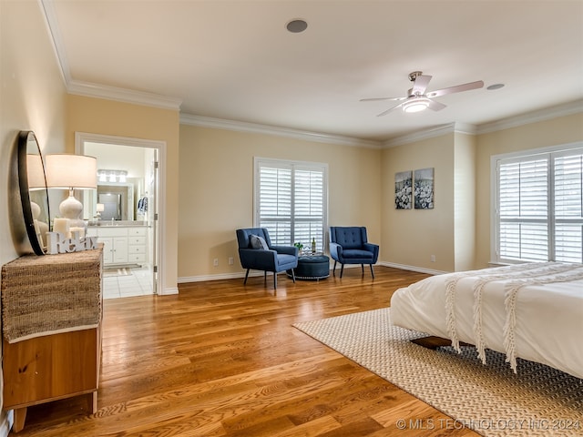 bedroom featuring multiple windows, hardwood / wood-style flooring, and ceiling fan