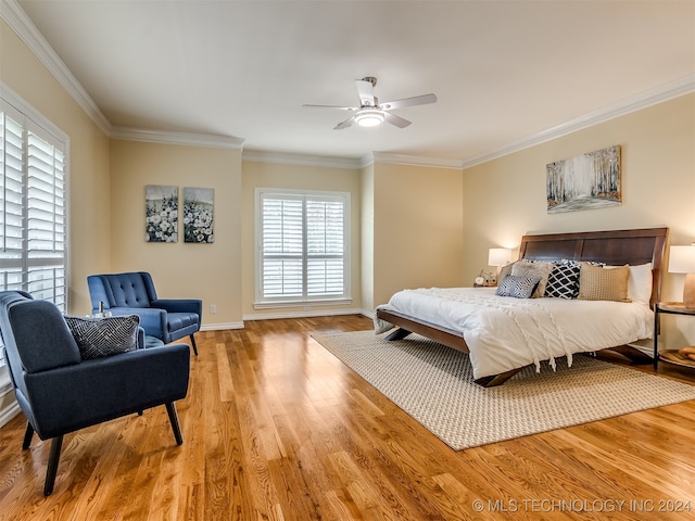 bedroom with crown molding, ceiling fan, and wood-type flooring