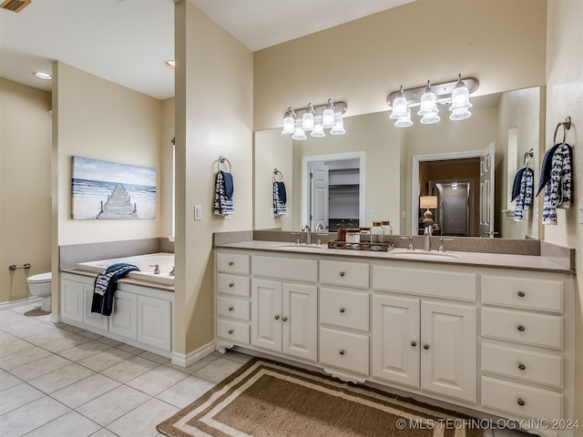 bathroom featuring vanity, toilet, a bathing tub, and tile patterned floors