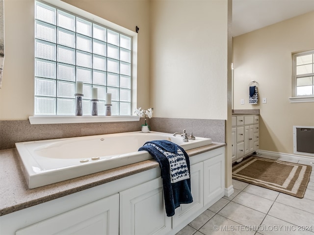 bathroom featuring plenty of natural light, vanity, a bathtub, and tile patterned floors