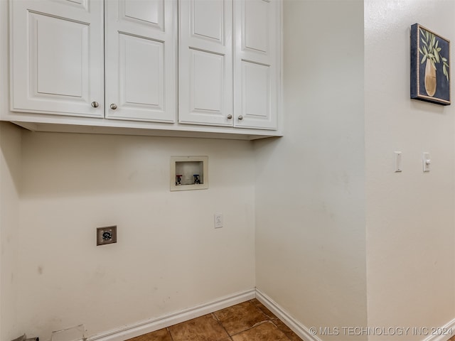 washroom with hookup for a washing machine, cabinets, hookup for an electric dryer, and tile patterned flooring