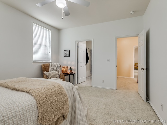 carpeted bedroom featuring ensuite bath and ceiling fan