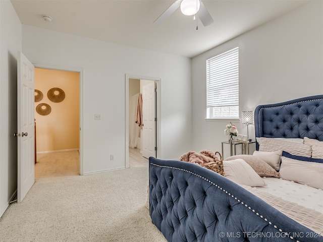 carpeted bedroom with ceiling fan and connected bathroom