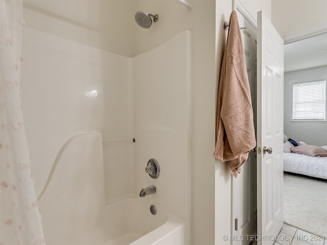 bathroom featuring tile patterned flooring and shower / bath combo with shower curtain