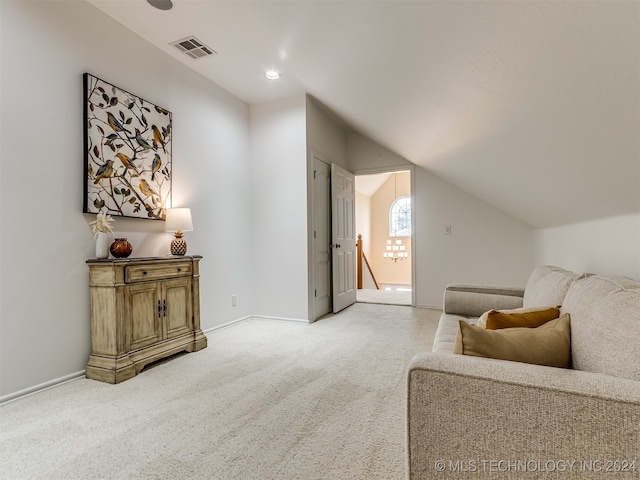 sitting room with vaulted ceiling and carpet floors