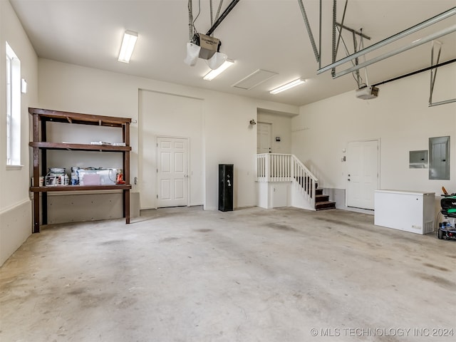 garage with electric panel and a garage door opener