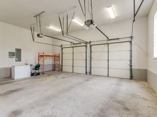 garage with electric panel and a garage door opener