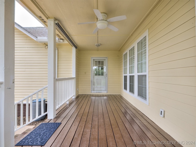 wooden terrace featuring ceiling fan