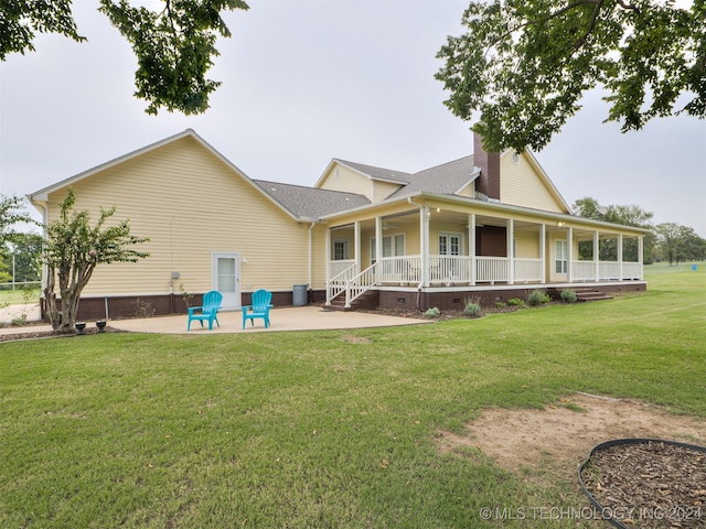 rear view of property with a yard, a patio area, and covered porch