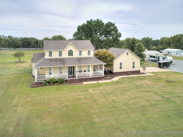 view of front of house with a front yard and a porch