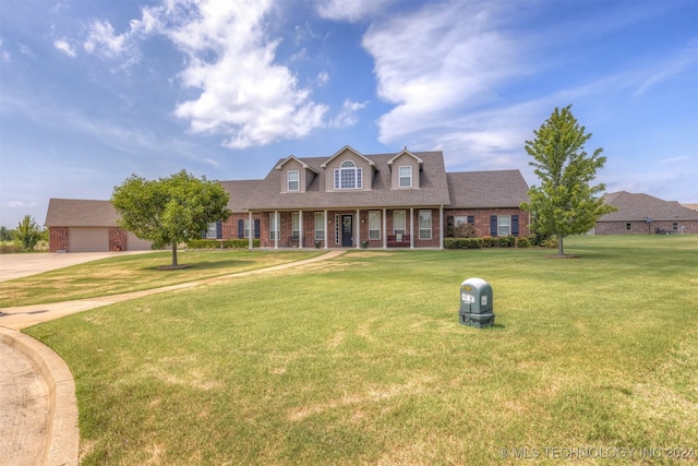 cape cod-style house with brick siding and a front yard