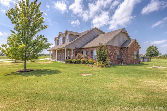 view of home's exterior featuring brick siding and a lawn