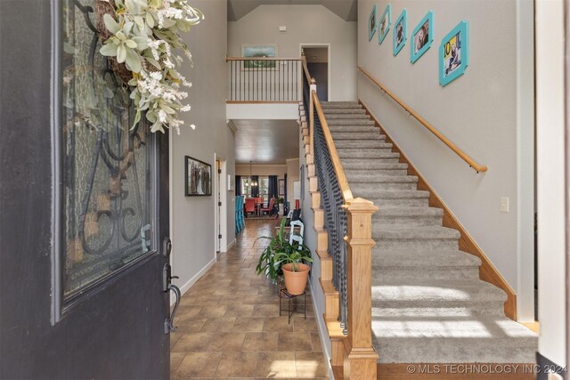 tiled foyer featuring a high ceiling