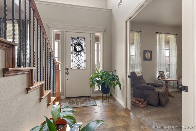 foyer entrance featuring light tile patterned floors