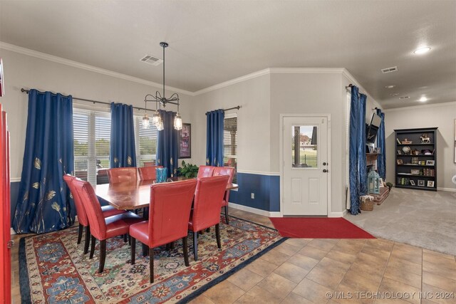 tiled dining area featuring a notable chandelier and crown molding