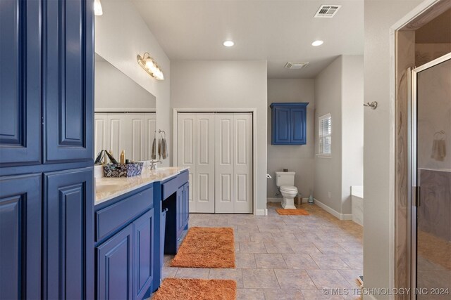 full bathroom featuring separate shower and tub, tile patterned floors, toilet, and vanity