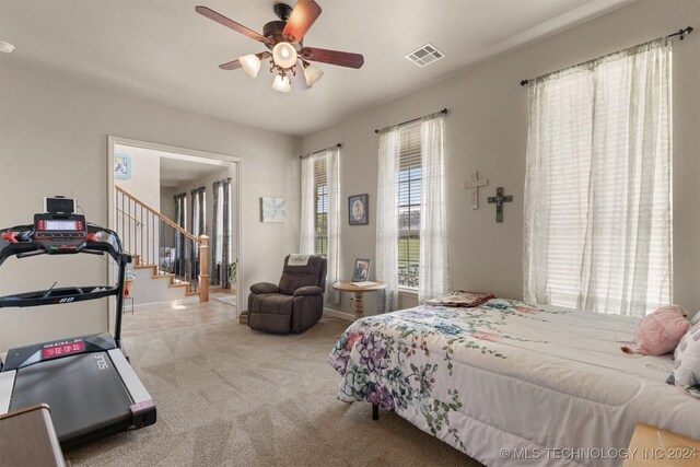 bedroom featuring ceiling fan and light carpet