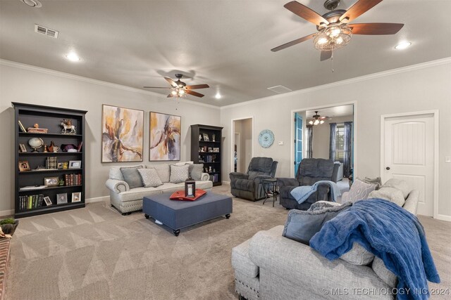 carpeted living room with ceiling fan and crown molding