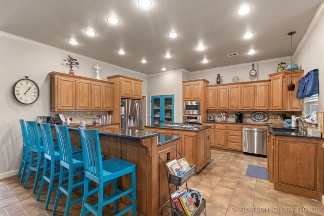 kitchen featuring decorative backsplash, stainless steel appliances, kitchen peninsula, and dark stone countertops